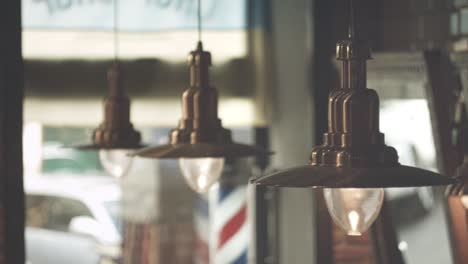 Vintage-hanging-lamps.-Barber-pole.-Abstract-background.-Hair-salon-interior